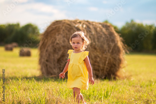 little girl in a field with yellow grass