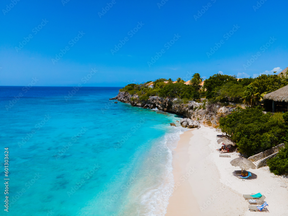 Playa Kalki Beach Caribbean island of Curacao, Playa Kalki in Curacao, white beach with a blue turqouse colored ocean. Drone aerial view above a beach with beach chairs and umbrellas