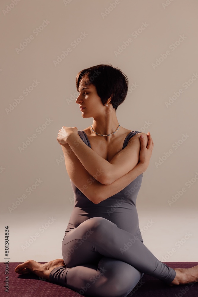 Young pregnant woman doing yoga exercises and meditating at studio. Health care, mindfulness and wellness concept. Young pregnant woman doing yoga exercises and meditating at studio. Health care, mindfulness and wellness concept.