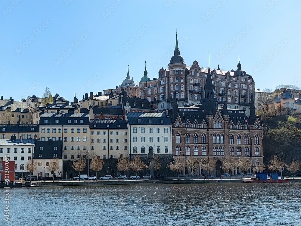 Obraz premium Panoramic view of Gamla Stan - the old town of Stockholm against the backdrop of water and blue sky.