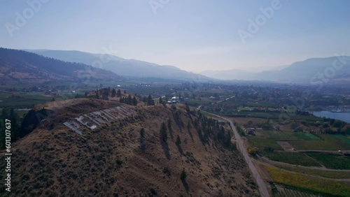 Drone circling over a mountain with the Penticton sign.