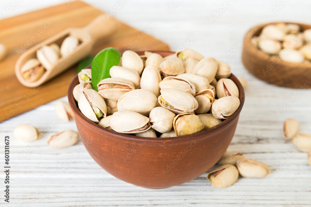 Fresh healthy Pistachios in bowl on colored table background. Top view Healthy eating concept. Super foods Fresh healthy Pistachios in bowl on colored table background. Top view Healthy eating concept. Super foods