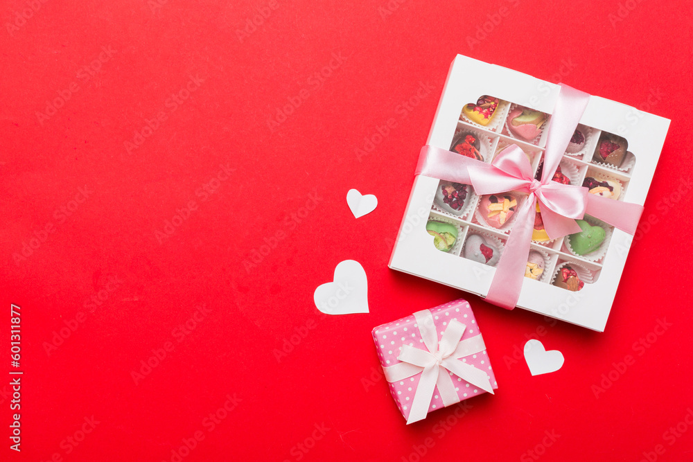 Valentine day composition: sweet candy, with gift boxes with bow and red felt hearts, photo template, background. Top View with copy space Valentine day composition: sweet candy, with gift boxes with bow and red felt hearts, photo template, background. Top View with copy space