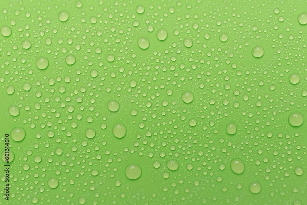 Water drops on color background, top view