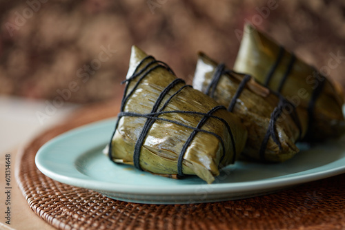 Three cooked rice dumplings on a plate