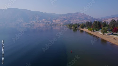 Wallpaper Mural Aerial shot flying along the lakeshore of Okanagan Lake on a hazy morning in British Columbia. Torontodigital.ca