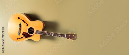 Classic Acoustic Guitar on a Yellow Background.  For Folk Music Admirers and Songwriters. photo