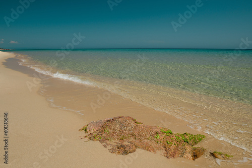 Relaxing beach and rocks on the Mediterranean Sea in Sardinia, Italy. Gentle waves and nobody around. Peaceful environment.