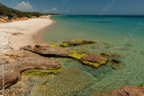 Beach and rocks on Mediterranean Sea, holiday destination in Sardinia Italy, beautiful sand and turquoise water.