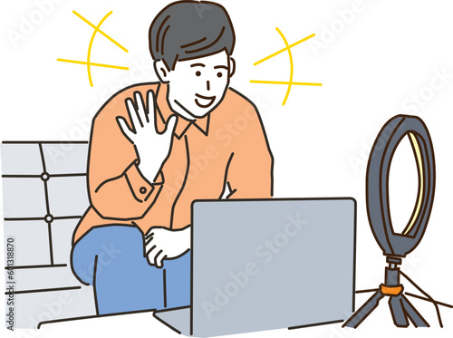 ノートパソコンで動画配信をする若い男性
