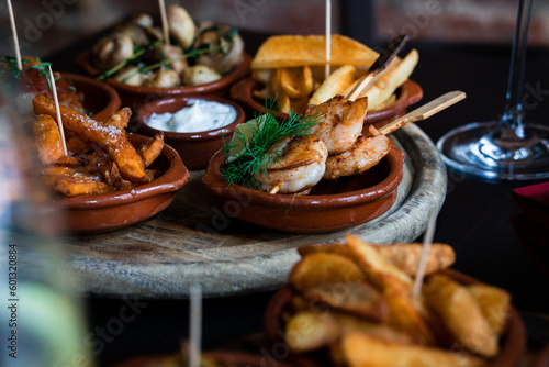 Tapas Bowls with Food arranged on a Table in a Tapas Bar.