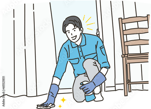 部屋で床掃除をする清掃業の若い男性
