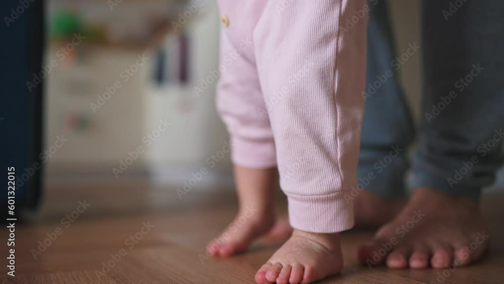 baby takes first steps. happy family a first steps kid dream concept. father teaches baby to take first steps close-up. newborn baby boy learning to step foot. father teaching daughter lifestyle baby takes first steps. happy family a first steps kid dream concept. father teaches baby to take first steps close-up. newborn baby boy learning to step foot. father teaching daughter lifestyle
