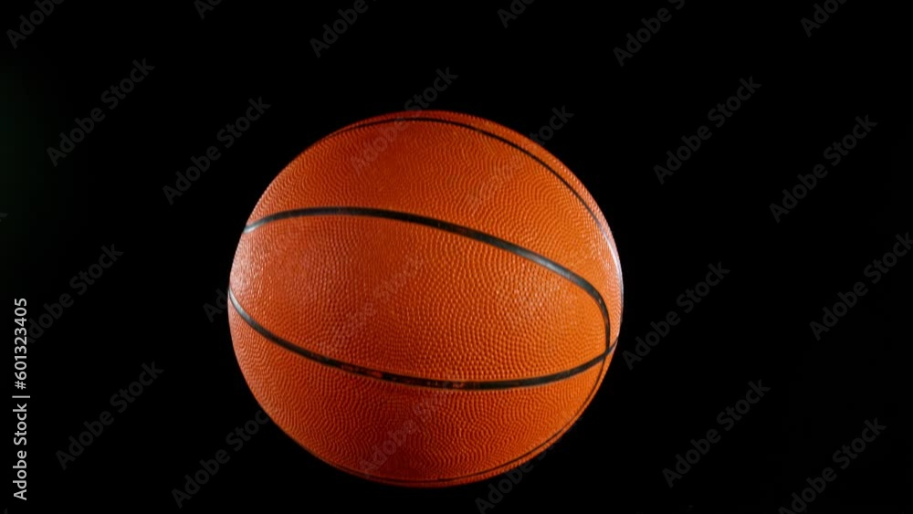 Super slow motion of falling basketball ball on water surface, black background. Filmed on high speed cinematic camera at 1000 fps. Super slow motion of falling basketball ball on water surface, black background. Filmed on high speed cinematic camera at 1000 fps.