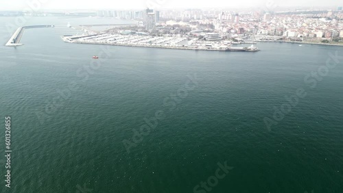 Atakoy Marina and Bakirkoy ferry with Istanbul city in the background reveal photo