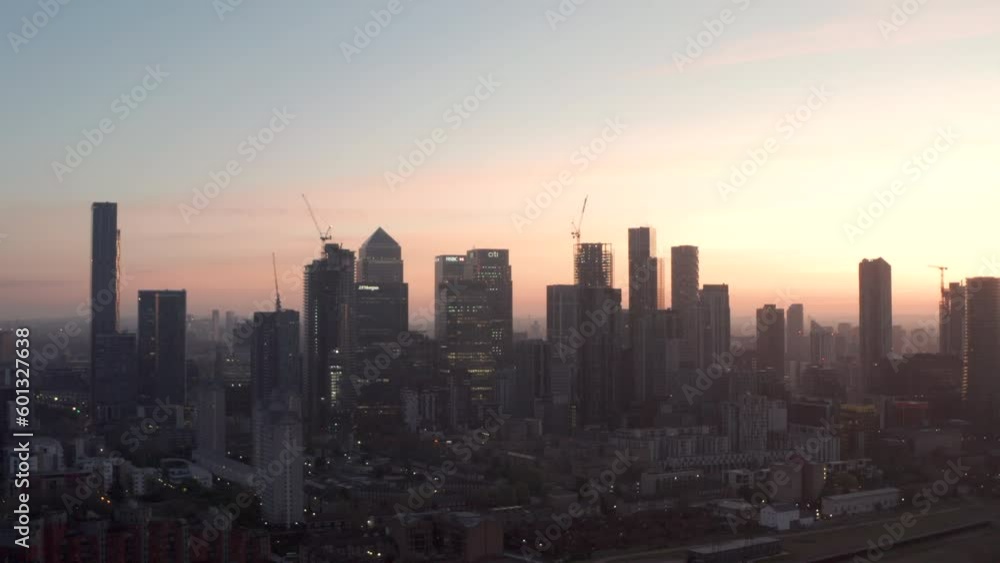 Long circling aerial shot of Canary Wharf Skyscrapers at dawn Long circling aerial shot of Canary Wharf Skyscrapers at dawn