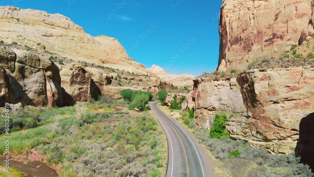 Amazing aerial view of a beautiful road across the canyon mountains and river, summer season Amazing aerial view of a beautiful road across the canyon mountains and river, summer season