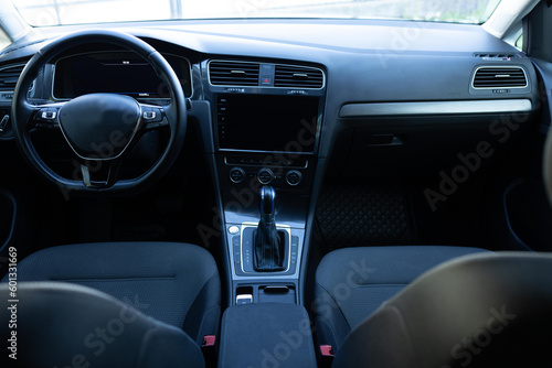 Car interior details adjustments. Inside car interior with front seats, driver and passenger, textile, windows, console, gear shift, electric buttons, digital speedometer