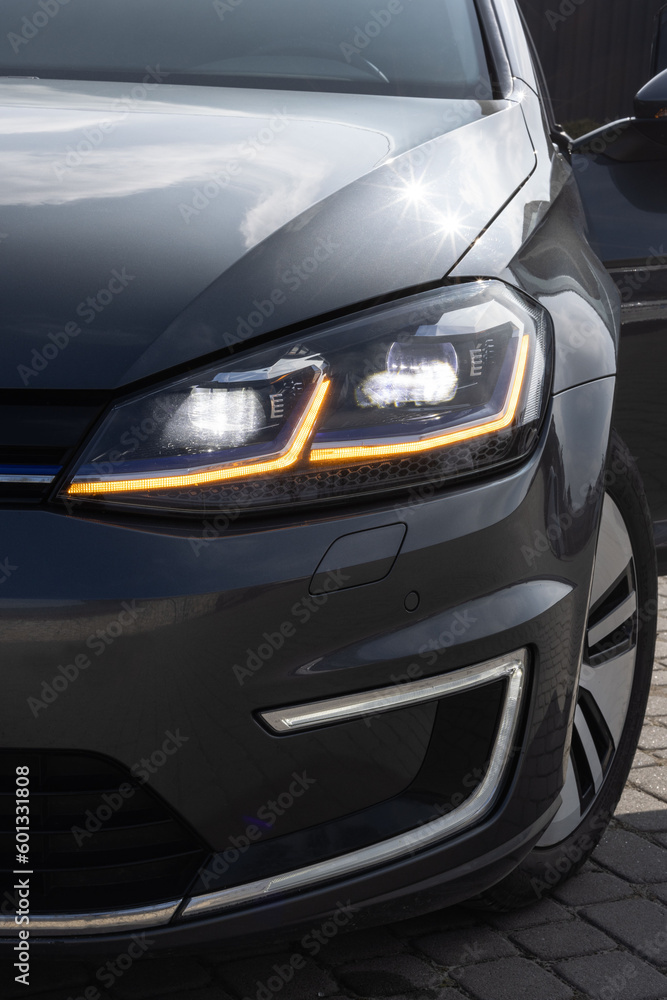 Car Front Full Led Light. Modern car headlamp flashing light with blinking on continuously indicator. Switched on led lights of luxury car. Car Blinker Light