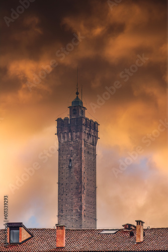 Bologna  Italy Asinelli Tower  part of Due Torri  medieval Two Towers city symbol  against dramatic orange clouds.