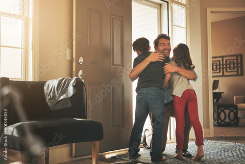 Home, love and a father hugging his kids after arriving through the front door after work during the day. Greeting, family or children with a man holding his son and daughter in the living room