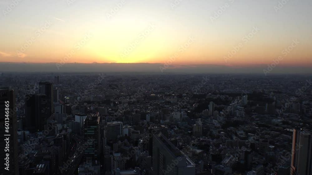 TOKYO, JAPAN : Aerial high angle sunset view of CITYSCAPE of TOKYO. Buildings and street around Shibuya station. Japanese urban city life, metropolis and travel concept. Time lapse shot, dusk to night TOKYO, JAPAN : Aerial high angle sunset view of CITYSCAPE of TOKYO. Buildings and street around Shibuya station. Japanese urban city life, metropolis and travel concept. Time lapse shot, dusk to night