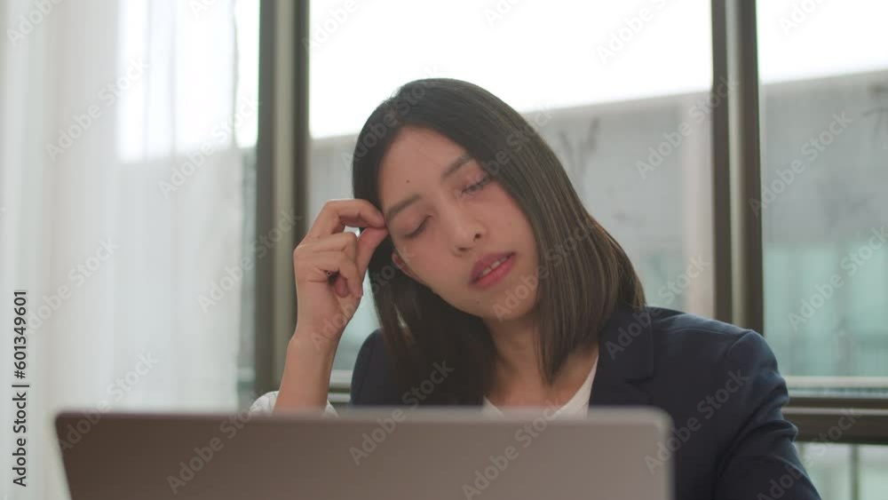 Close-up Asian businesswoman thinking about her work and using a computer laptop in the office. Close-up Asian businesswoman thinking about her work and using a computer laptop in the office.