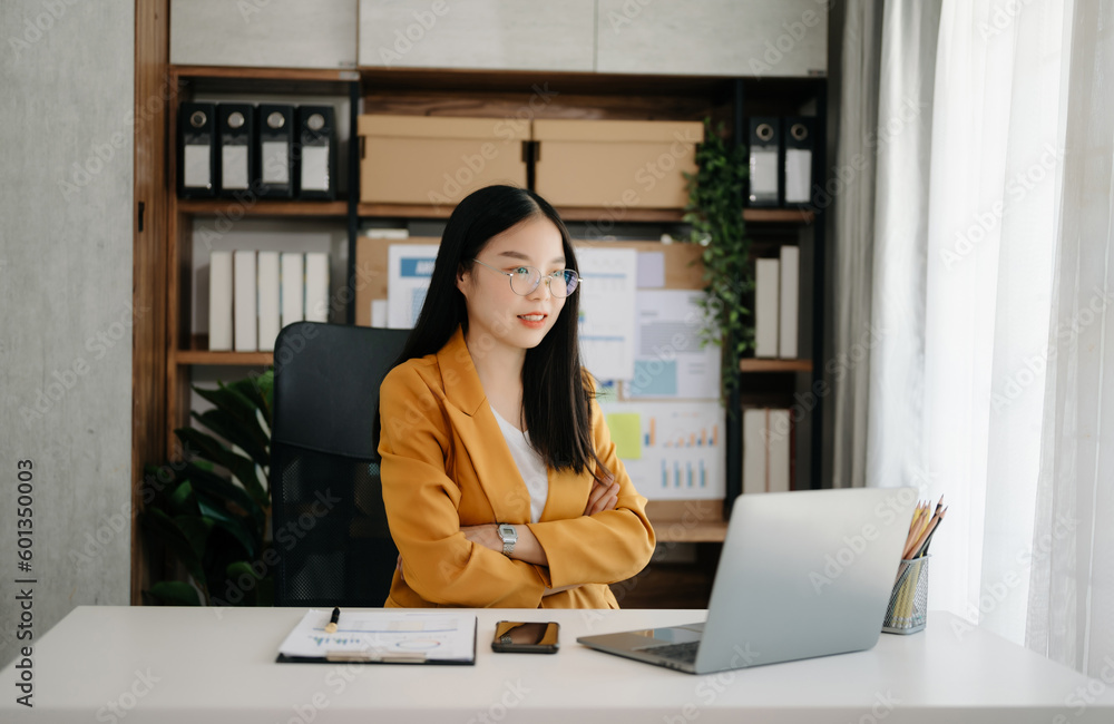 Business woman using tablet and laptop for doing math finance on an office desk, tax, report, accounting, statistics, and analytical research concept Business woman using tablet and laptop for doing math finance on an office desk, tax, report, accounting, statistics, and analytical research concept