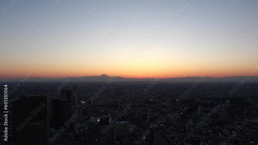 TOKYO, JAPAN : Aerial sunrise CITYSCAPE of TOKYO and MOUNT FUJI. View of rising sun and buildings around Shibuya. Japanese urban city life and nature concept. Long time lapse video, night to morning. TOKYO, JAPAN : Aerial sunrise CITYSCAPE of TOKYO and MOUNT FUJI. View of rising sun and buildings around Shibuya. Japanese urban city life and nature concept. Long time lapse video, night to morning.