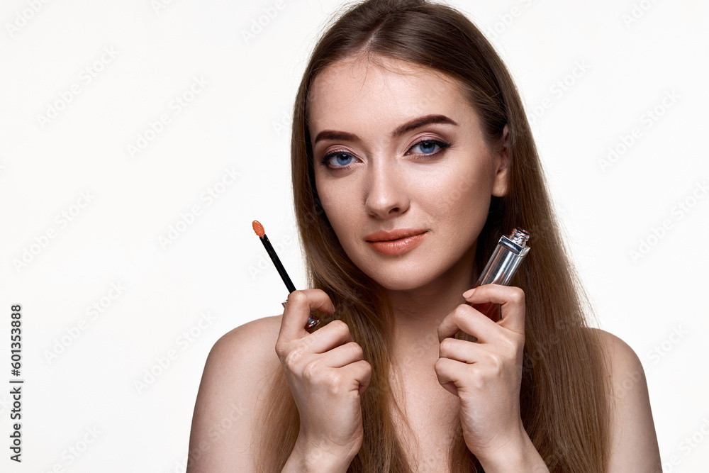 beautiful young woman testing nude lip gloss beautiful young woman testing nude lip gloss
