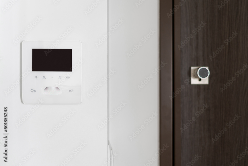 Intercom with electronic doorbell on white wall Intercom with electronic doorbell on white wall