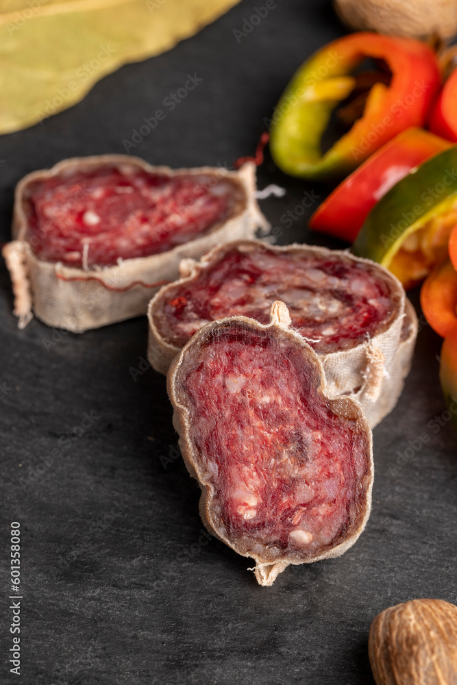 Unpeeled sliced pork salami with spices Unpeeled sliced pork salami with spices