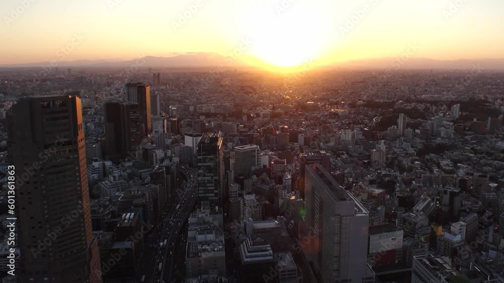 TOKYO, JAPAN : Aerial sunset CITYSCAPE of TOKYO and MOUNT FUJI. View of buildings around Shibuya station. Time lapse shot, dusk to night. Japanese urban city life and metropolis concept, 4K video. TOKYO, JAPAN : Aerial sunset CITYSCAPE of TOKYO and MOUNT FUJI. View of buildings around Shibuya station. Time lapse shot, dusk to night. Japanese urban city life and metropolis concept, 4K video.