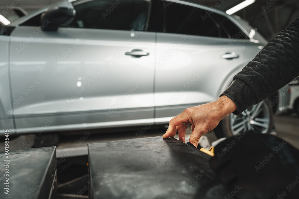 Close up of hands of car mechanic in auto repair service Close up of hands of car mechanic in auto repair service