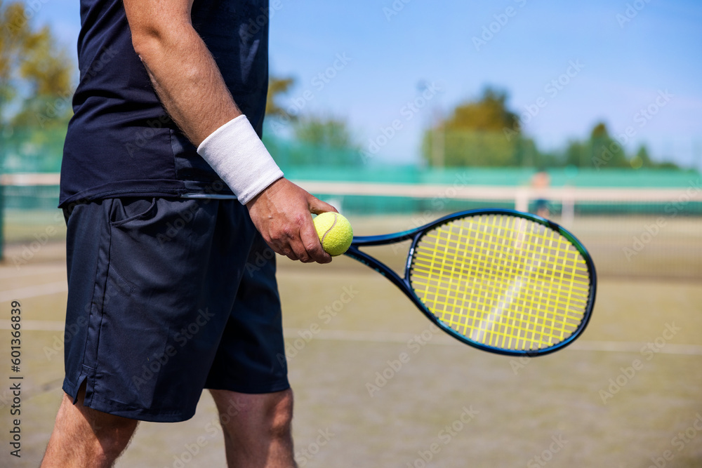 tennis player with racket and ball in hands ready to play at outdoor court