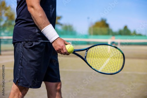 tennis player with racket and ball in hands ready to play at outdoor court © ronstik