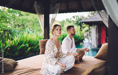 Fotografie Portrait of Caucaisan woman doing yoga together with husband during weekend time