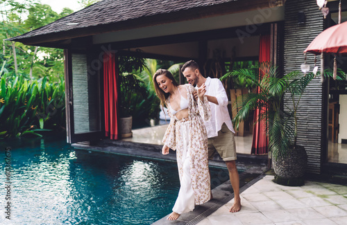 Caucasian boyfriend 30s enjoying relationship with cheerful girlfriend in casual wear, happy male and female best friends bonding during communication leisure for feeling warm vibes on honeymoon photo