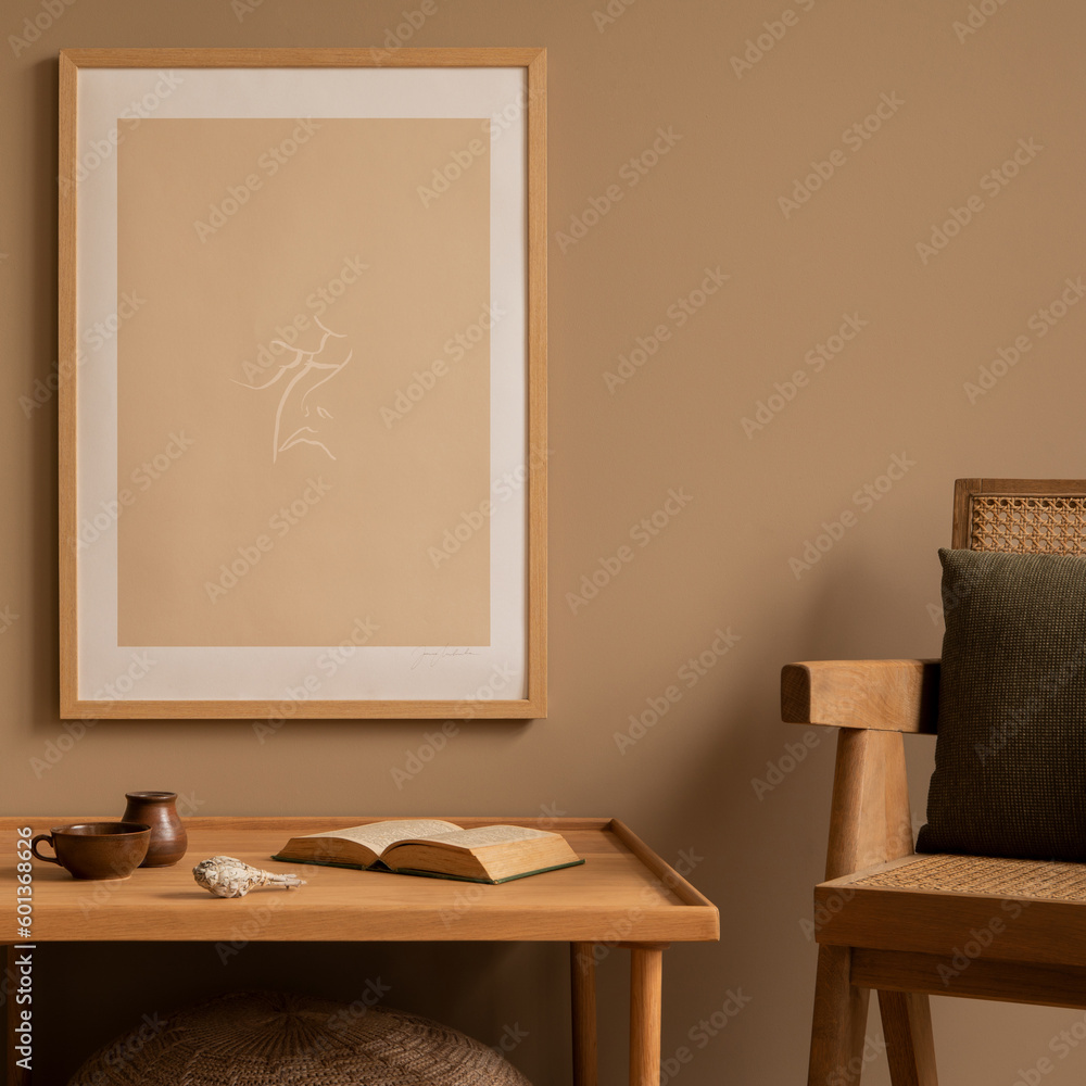Warm and cozy composition of living room interior with mock up poster frame, simple wooden table, rattan armchair, partition wall, plants, book and personal accessories. Home decor. Template. Warm and cozy composition of living room interior with mock up poster frame, simple wooden table, rattan armchair, partition wall, plants, book and personal accessories. Home decor. Template.