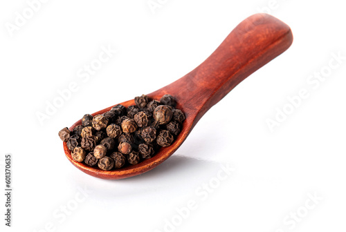 Black pepper in a wooden spoon, isolated on a white background