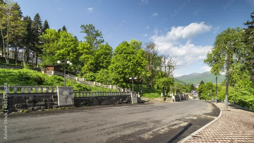 Time lapse of a traffic road in Dilijan city in Armenia with mountains and blue sky in background Time lapse of a traffic road in Dilijan city in Armenia with mountains and blue sky in background