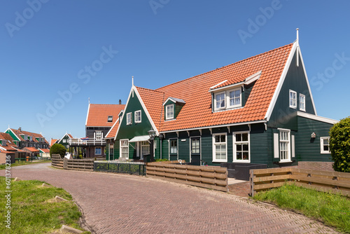 Street in the Dutch village of Marken with colorful wooden houses on the peninsula at the Markermeer.