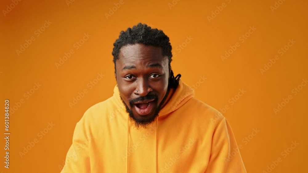 Portrait of shocked young African man on yellow background Portrait of shocked young African man on yellow background