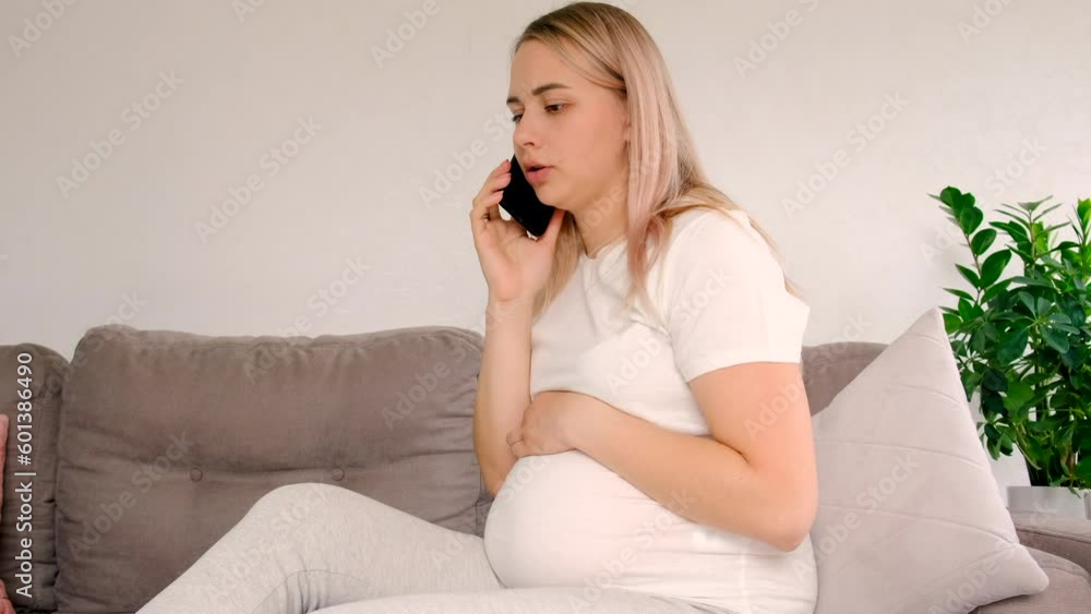 A pregnant woman speaks on the phone. Selective focus. A pregnant woman speaks on the phone. Selective focus.