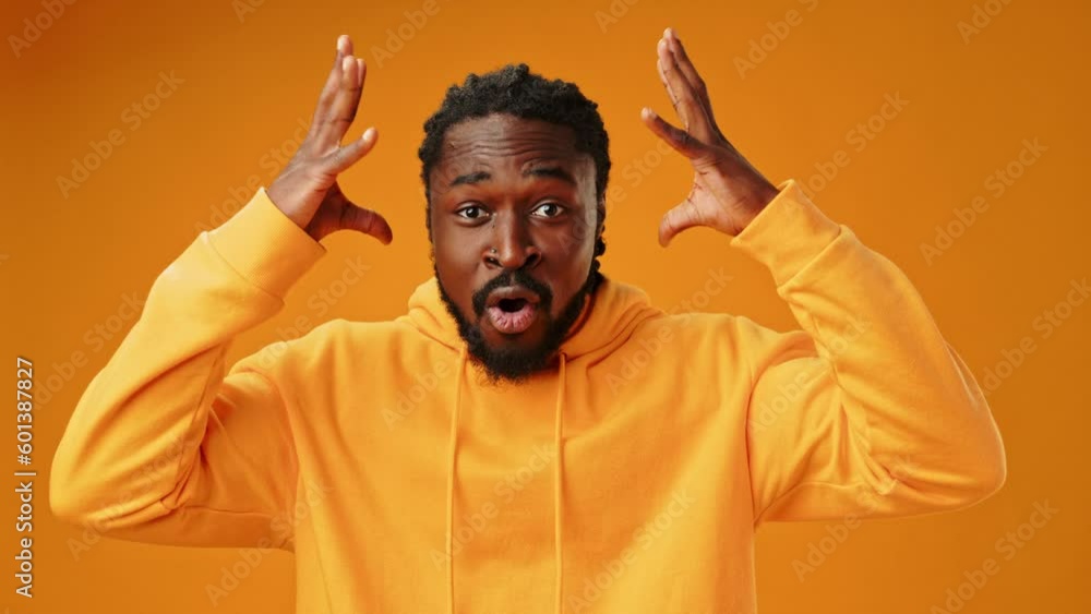 Portrait of shocked young African man on yellow background Portrait of shocked young African man on yellow background