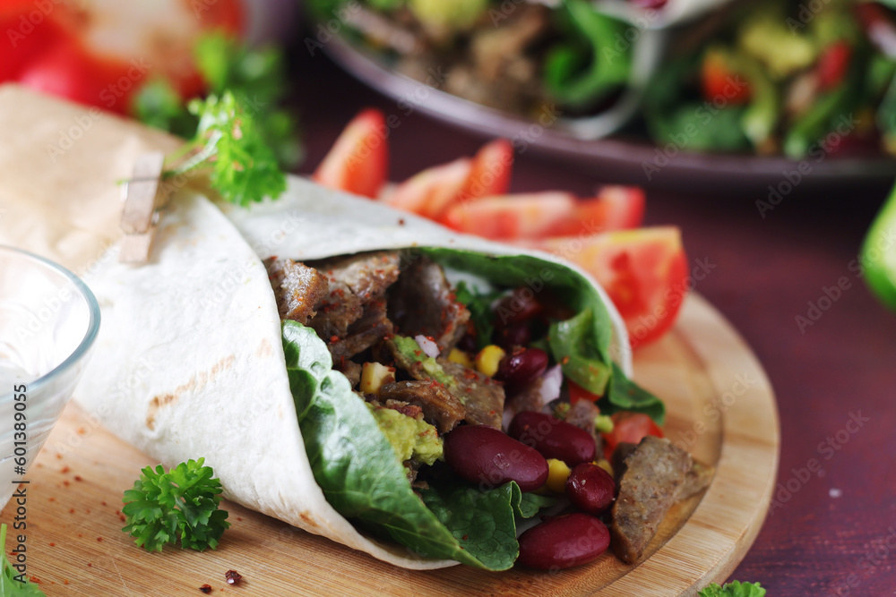 Burrito - typical Texas and Mexican cuisine wrap dish Burrito - typical Texas and Mexican cuisine wrap dish