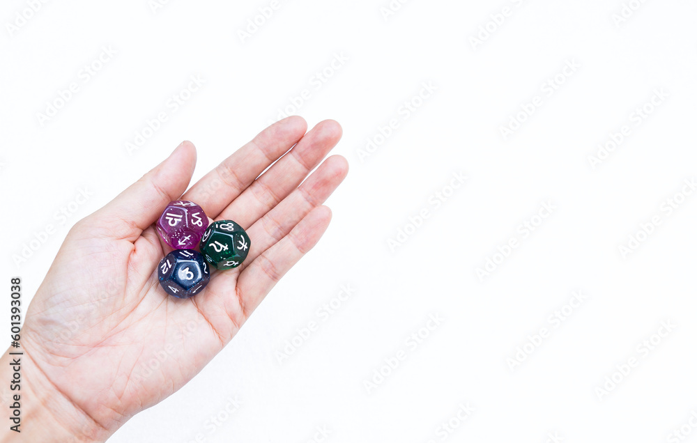 Dice divination in girl hand isolate on white background, astrological dices fortune telling divination tools, third house with libra zodiac sign and Saturn planet symbol Dice divination in girl hand isolate on white background, astrological dices fortune telling divination tools, third house with libra zodiac sign and Saturn planet symbol