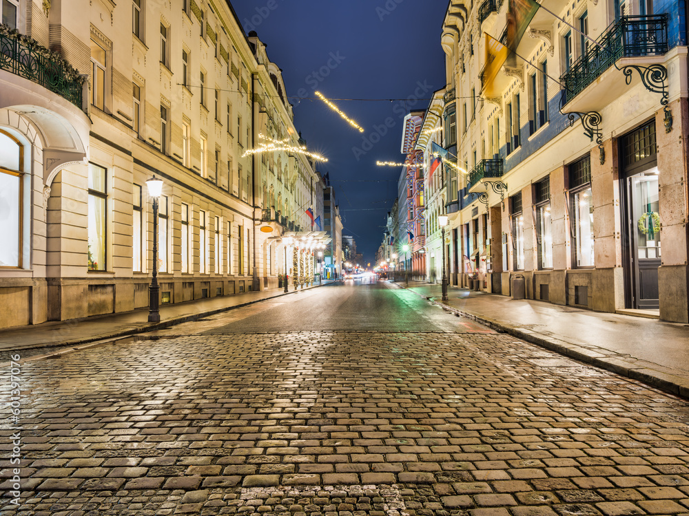 Obraz premium Cobblestone Miklosiceva Street lit up with Christmas lights at night in Ljubljana, Slovenia