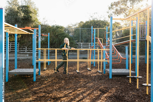 An Australian primary school girl playing on a playground in the school yard at recess