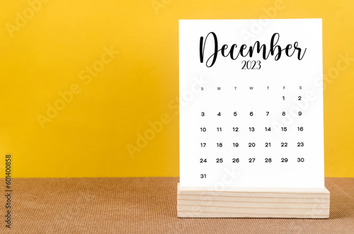 The December 2023 Monthly calendar for 2023 year on yellow table.